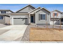 Charming single Gathering home with gray siding, a concrete driveway, and a two car garage at 9112 Telluride Ct, Commerce City, CO 80022