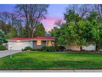 Charming single story home boasts a well-manicured lawn and mature trees at 7900 Crest Dr, Lakewood, CO 80214