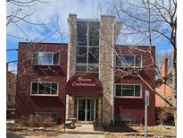Brick condominium building featuring a covered entrance, stone accents, and lots of natural light at 1131 N Lafayette St # 304, Denver, CO 80218