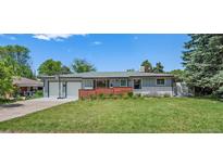 Charming home with well-maintained front yard, lovely landscaping, and attached two-car garage at 4855 E Atlantic Pl, Denver, CO 80222