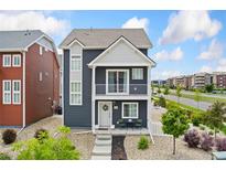 Charming two-story home with a balcony, landscaped front yard, and stylish exterior features at 18552 E 54Th Ave, Denver, CO 80249