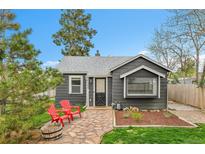 Charming front exterior with stone pathway, modern paint, and inviting red Adirondack chairs at 1000 S Perry St, Denver, CO 80219