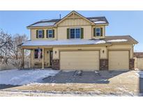 Two-story house with a two-car garage and snow-covered front yard at 5834 Twilight Ave, Firestone, CO 80504