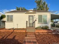 Charming single-story home featuring a well-kept lawn and cozy front porch at 616 Meade St, Denver, CO 80204