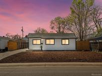 Charming single-story home with dark trim windows and a well-manicured front yard at 355 Perry St, Denver, CO 80219