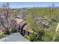 Charming two-story home features a unique tower and lush mature trees, creating a serene setting at 306 E Cannon St, Lafayette, CO 80026
