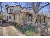 Charming home with a unique tower feature, complemented by a cozy porch, driveway and a fenced yard at 306 E Cannon St, Lafayette, CO 80026