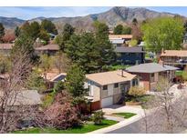 Charming home nestled in a tree-filled neighborhood with mountain views at 12662 W Asbury Pl, Lakewood, CO 80228