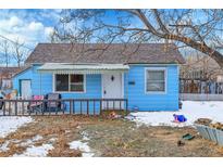 Charming blue bungalow with a covered porch and fenced yard at 7111 Monaco St, Commerce City, CO 80022