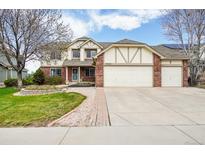Charming two-story home featuring a three-car garage, brick accents, and a beautifully landscaped front yard at 6565 W 99Th Ave, Broomfield, CO 80021