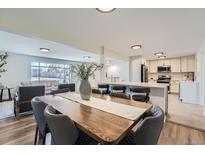 Elegant dining area flows into an open kitchen with stainless steel appliances and bar seating at 6923 S Albion St, Centennial, CO 80122