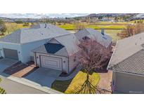 Charming home featuring mature landscaping, a well-maintained exterior, and an attached garage on a sunny day at 1950 Five Iron Dr, Castle Rock, CO 80104