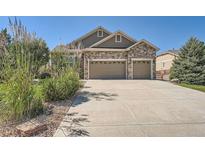 Two-story house with stone and siding, two-car garage, and landscaping at 4993 Sedona Cir, Parker, CO 80134