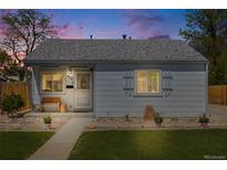 Charming single-story home featuring a well-maintained lawn and inviting front porch at 935 Newark St, Aurora, CO 80010