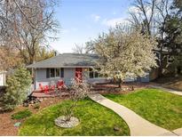 Charming home featuring a landscaped front yard with a beautiful walkway and vibrant red accents at 1180 S Honey Way, Denver, CO 80224