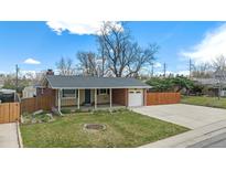 Charming single-story home with brick accents, a covered porch, and a well-maintained front yard and driveway at 6676 S Kit Carson St, Centennial, CO 80121