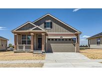 Charming single-Gathering home showcasing a welcoming porch and a spacious two-car garage in a suburban neighborhood at 5165 N Quemoy St, Aurora, CO 80019
