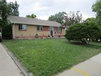 Charming ranch-style home with a brick exterior and well-maintained front yard at 5640 E 67Th Pl, Commerce City, CO 80022