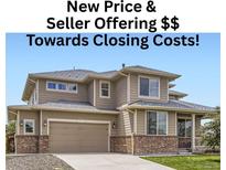 Charming two-story home with a two-car garage, a covered porch, and appealing architectural details at 785 Iris St, Brighton, CO 80601