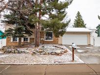 Charming two-story brick home featuring a two-car garage and well-manicured front yard at 17973 E Iowa Dr, Aurora, CO 80017