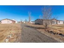 Spacious property with a long driveway, detached garage, and two mobile homes at 501 Zante Way, Lochbuie, CO 80603