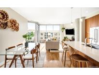 Bright living room featuring hardwood floors, large windows, and an open-concept design at 4200 W 17Th Ave # 611, Denver, CO 80204