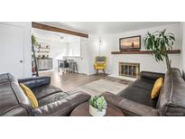 Comfortable living room with a fireplace, television and decorative touches at 6922 Vance St, Arvada, CO 80003