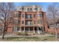 Striking red brick condo building boasting an inviting front porch and wrought iron details at 410 Acoma St # 515, Denver, CO 80204