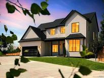 Beautifully designed two-story home featuring a manicured lawn, black trim and a two car garage at 6725 Beech Ct, Arvada, CO 80004