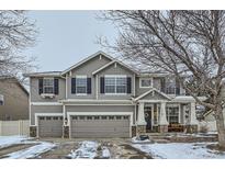 Charming two-story home features a welcoming front porch and a three-car garage at 11191 Cimarron St, Firestone, CO 80504