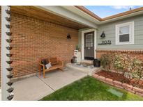 Inviting front porch with brick facade, bench, and address display creates curb appeal at 11031 Marshall St, Westminster, CO 80020
