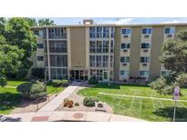 Inviting condo building with well-maintained landscaping, walkway, and building signage at 13626 E Bates Ave # 302, Aurora, CO 80014