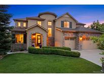 Charming two-story home boasting a well-manicured lawn, stone accents and a three-car garage at 12147 S Shady Pine Ct, Parker, CO 80134