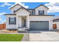 Attractive two-story home with a well-manicured lawn, porch, and garage at 2177 Garden Ave, Brighton, CO 80601