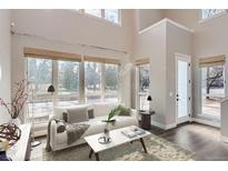 Bright living room with large windows, hardwood floors, and modern decor, offering natural light and a cozy ambiance at 2951 E Evans Ave, Denver, CO 80210