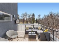 Relaxing rooftop deck features sectional sofa, chairs, and city views at 2951 E Evans Ave, Denver, CO 80210