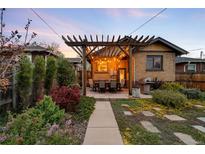 Outdoor dining area boasts a beautiful pergola and well-manicured landscaping at 1918 S Lincoln St, Denver, CO 80210