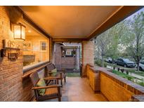 Inviting brick front porch with seating area and neighborhood views, perfect for relaxing outdoors at 1918 S Lincoln St, Denver, CO 80210