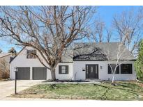 Charming home featuring a well-maintained lawn, mature trees, and a two-car garage at 6707 S Elizabeth St, Centennial, CO 80122