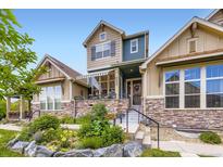 Charming two-story home with well-maintained landscaping and a stone-accented facade at 529 Gallegos Cir, Erie, CO 80516