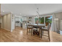 Bright, open living space with hardwood floors, modern kitchen, and dining area with scenic mountain views at 25694 Stansbery St, Conifer, CO 80433