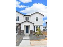 Charming two-story home with white siding, stone accents, covered entryway and manicured landscaping at 5780 N Killarney Way, Aurora, CO 80019