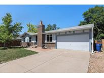 Charming single-Gathering home featuring an attached two-car garage and a well-maintained front yard at 6436 S Kline St, Littleton, CO 80127