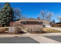 Charming brick ranch-style home with mature trees, a driveway, and a two-car garage at 2365 S Holly Pl, Denver, CO 80222