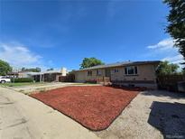 Charming single-story brick home with red mulch landscaping at 2865 Carnation Way, Thornton, CO 80229