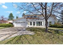 Charming home featuring a landscaped front yard, white exterior, and attached two-car garage at 5467 W Hinsdale Pl, Littleton, CO 80128