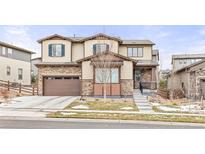 Charming two-story home featuring a stone and siding facade, attached garage, and welcoming front steps at 8035 S Kewaunee St, Aurora, CO 80016