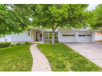 Charming ranch-style home featuring a well-manicured lawn and a two-car garage, ideal for suburban living at 6748 S Gallup St, Littleton, CO 80120
