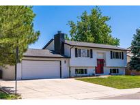 Charming two-story home with a freshly painted white exterior and a neatly maintained front lawn at 9410 Perry St, Westminster, CO 80031