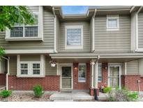 Charming two-story townhome with brick accents, inviting front porch, and manicured landscaping at 9110 Gale Blvd # 3, Thornton, CO 80260
